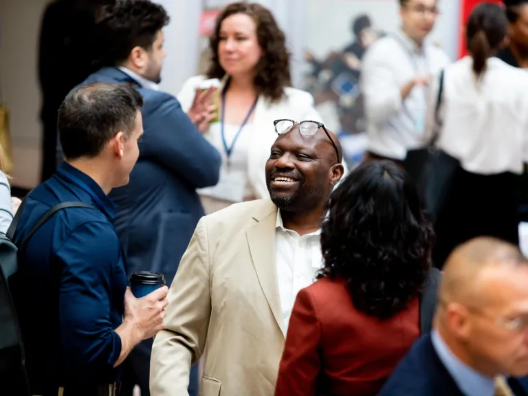 Two people chatting in focus among crowd