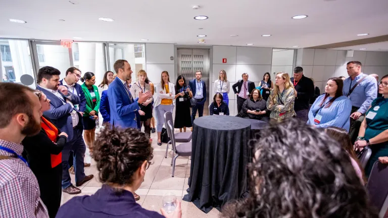 Large group of people in discussion standing in a circle 