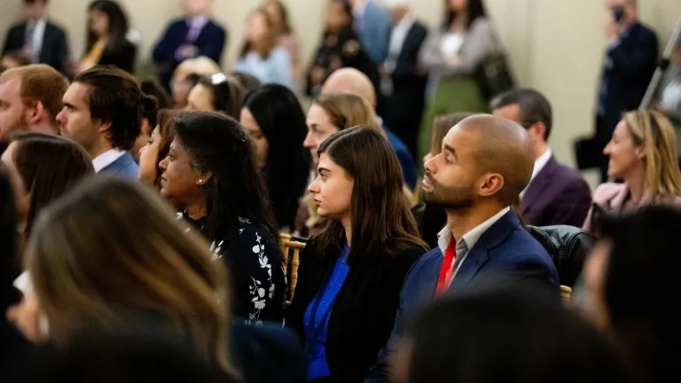 Side angle view of panel audience facing left