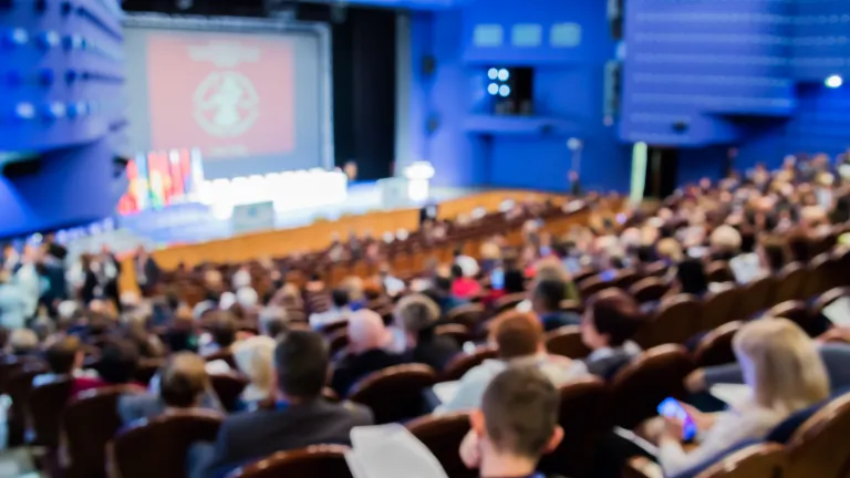 Defocused shot of people in auditorium
