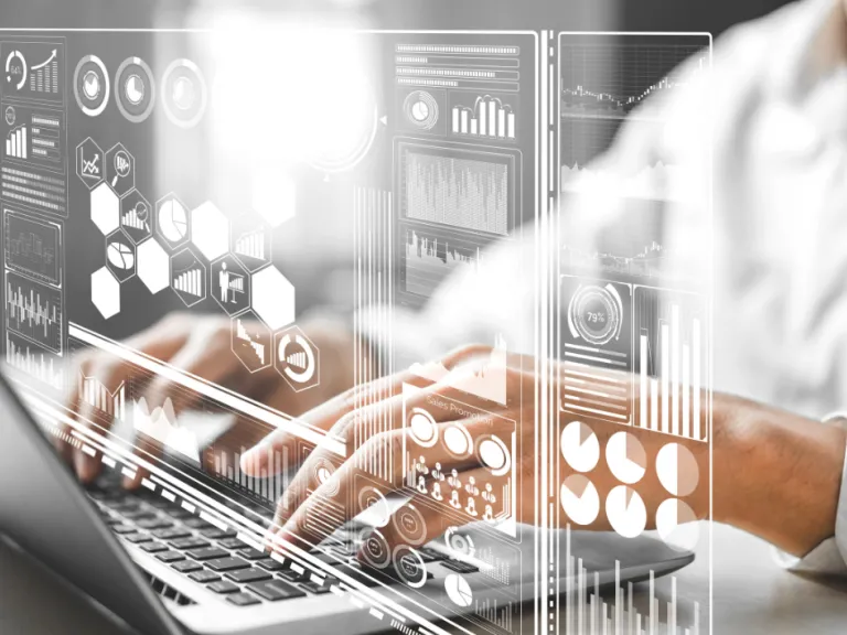 A person using the computer with data and tech floating around